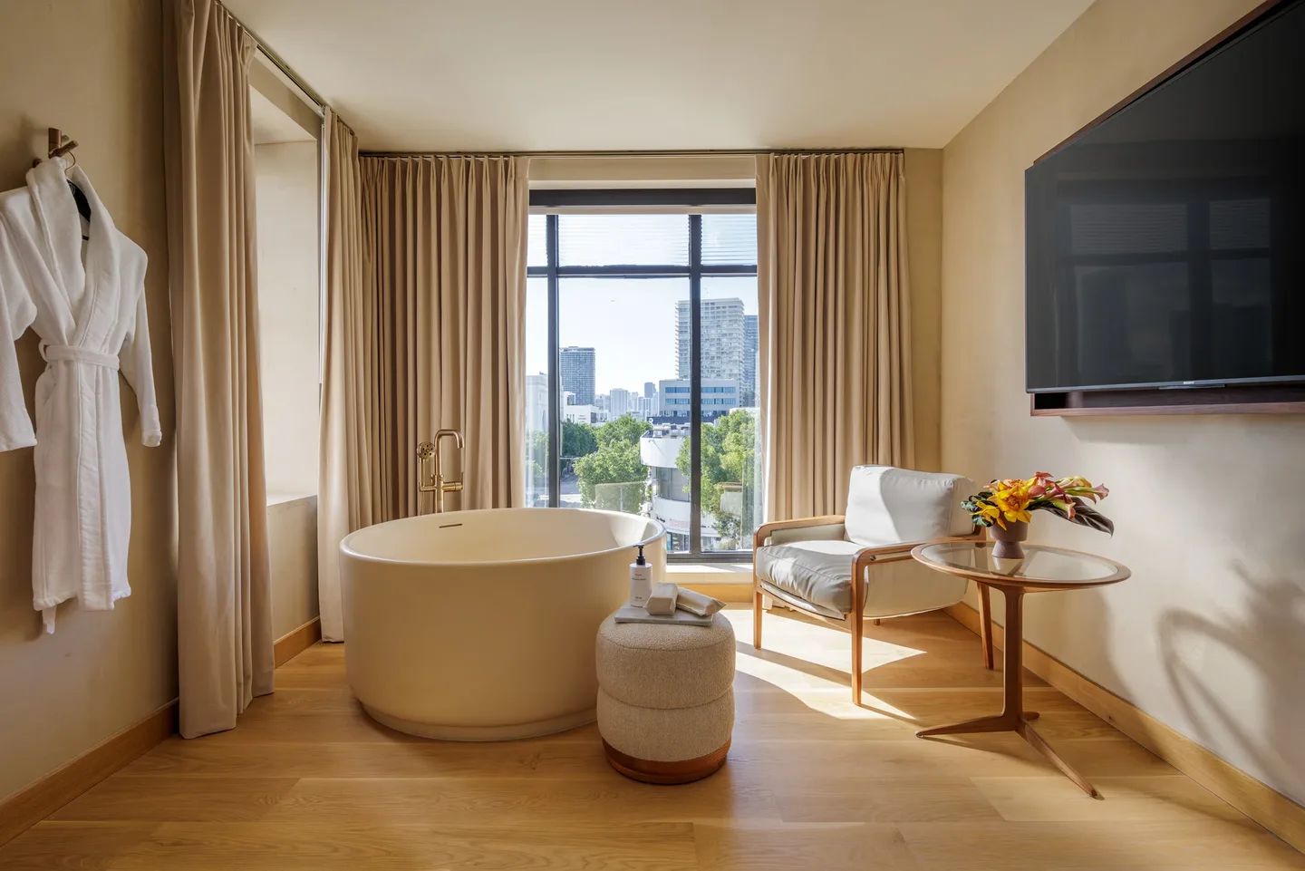 A suite bathroom with stone surfaces, a walk-in shower and warm directional lighting